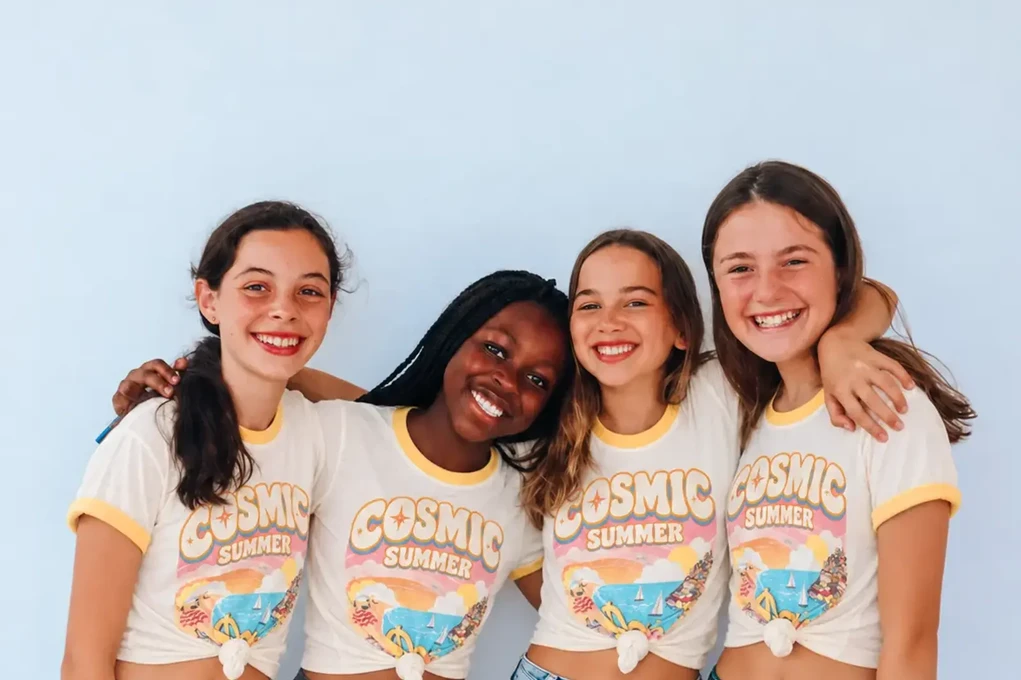 Four girls wearing Cosmic Summer vintage ringer tees